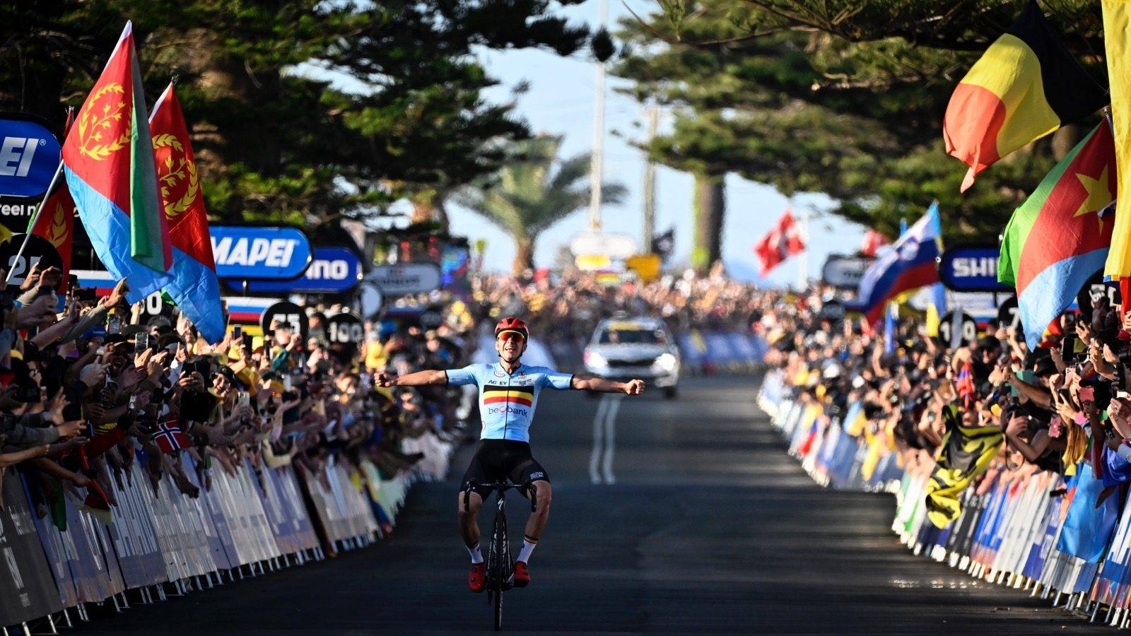 Belgian Remco Evenepoel celebrates as he crosses the finish line to win the men's elite road race at the UCI Road World Championships Cycling 2022, in Wollongong, Australia, Sunday 25 September 2022. The Worlds are taking place from 18 to 25 September. BELGA PHOTO DIRK WAEM